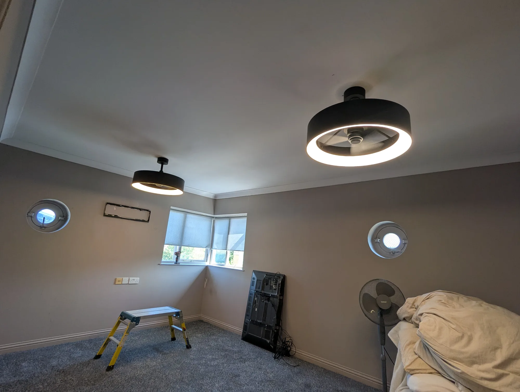 Black halo ceiling lights installed in a bedroom