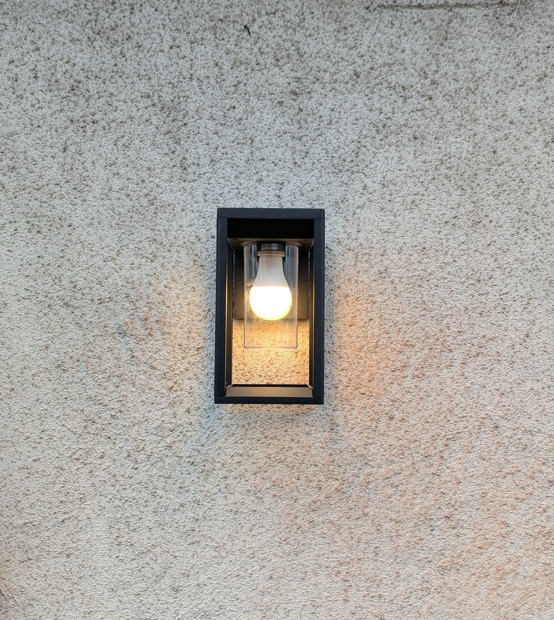 Outdoor wall lantern installed and lit